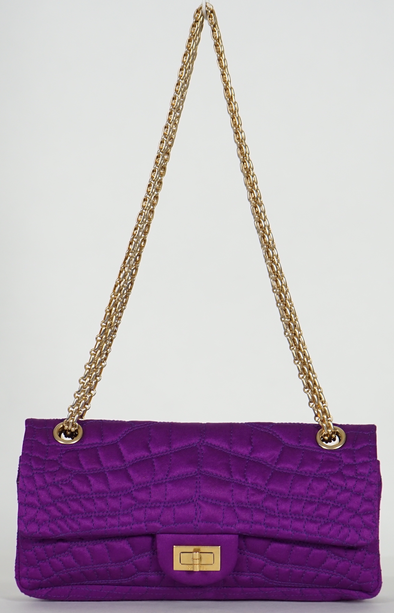 A Chanel medium-sized 2-55 bag in purple silk satin stitched with a quilted crocodile pattern, width 24cm, height 15cm, depth 6cm Single handle 112cm, Double handles 65cm